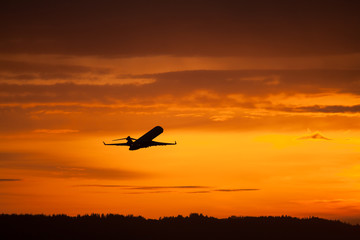 airplane takeoff in sunset