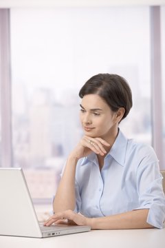 Female office worker with laptop