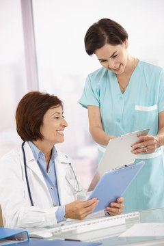 Smiling medical expertise working with assistant