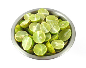 Sliced key limes in stainless steel bowl
