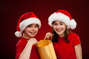 Christmas time - girl and boy with Santa Claus Hat