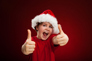 Fototapeta na wymiar Christmas time - boy with Santa Claus Hat
