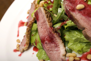 Meat with salad served on the white round  plate