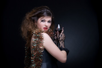 Closeup portrait of girl with red lips, tinsel and wineglass on