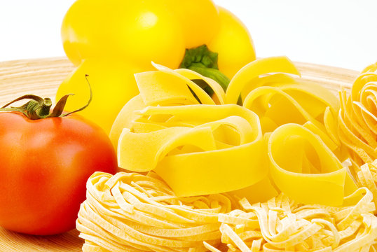 raw Italian pasta, pepper and tomato on plate