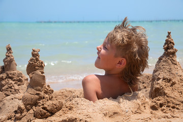 boy buried in sand