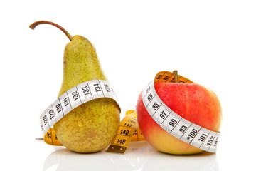 Pear and apple with measure tape over white background
