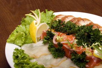 Appetizer made of meat and fish served with salad