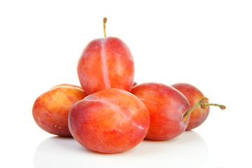 couple of plums in closeup over white background