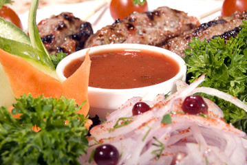 Fried meat served with tomato sauce and salad