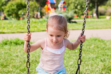 little girl swinging on a swing