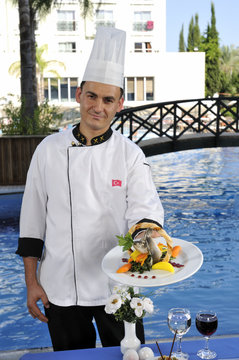 Chef Proudly Serving Gourmet Food He Prepared.