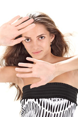 Naklejka premium Young pretty lady with long hairs defending with hands studio po