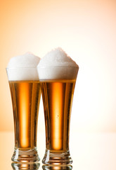 Beer glasses against the colorful gradient background