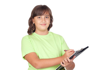 Fototapeta premium Adorable preteen girl writing on clipboard