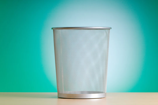 Garbage bin with paper waste isolated on white