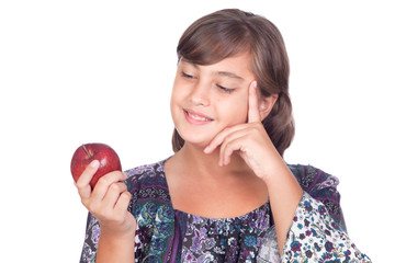 Adorable preteen girl with a apple thinking