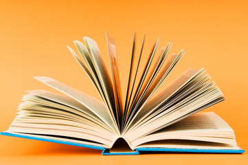 Stack of books on the color background