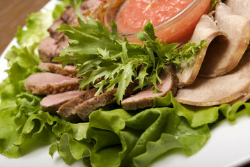 Appetizer made of  meat delicacies and salad
