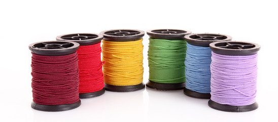 Few bobbins isolated on white