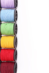 Few bobbins isolated on white