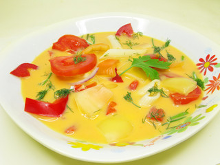 yellow vegetable soup with tomato and pasta