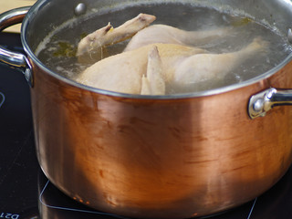 whole chicken in a soup pot