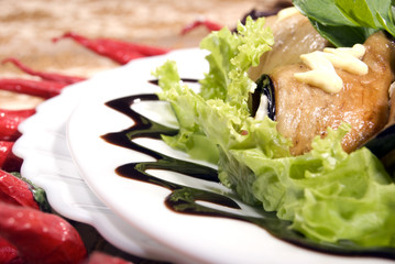 Appetizer made of rolled egg-plants served with salad