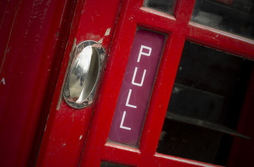 Fototapeta premium Pull sign on old telephone box