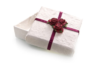 a box with a red bow and roses