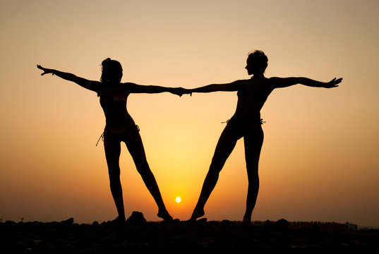 Silhouette of two young women