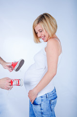 Joy expectations. Cheerful young pregnant woman in the studio