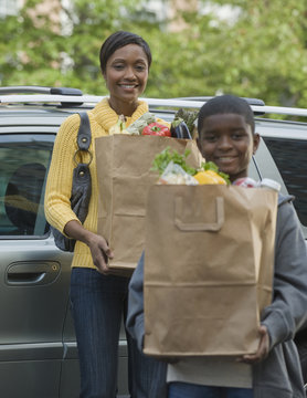 African Boy Helping Mother Unload Groceries