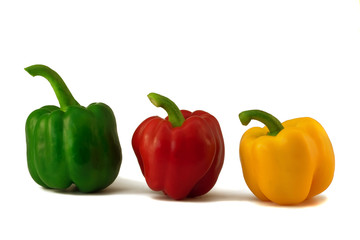 Three multi-coloured pepper: green, red, yellow