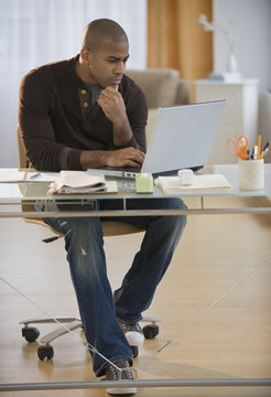 African American Man Working On Laptop In Home Office