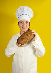 Baker holding fresh bread