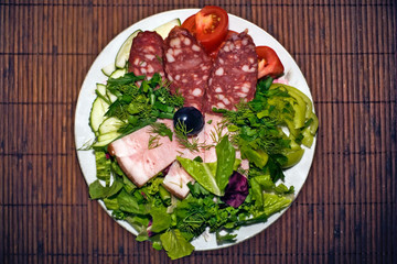 Salade with meet and vegetables on plateful