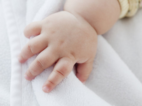 Close up of mixed race baby girlÕs hand