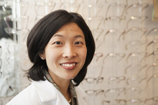 Korean optician standing in store