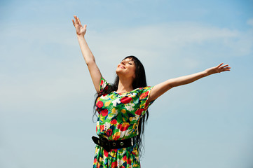 happy woman against blue sky