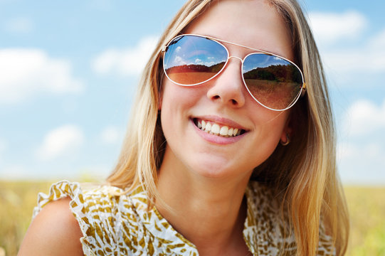 happy young woman in sunglasses