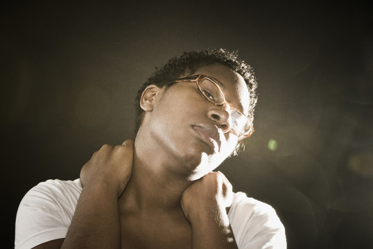 African woman rubbing neck