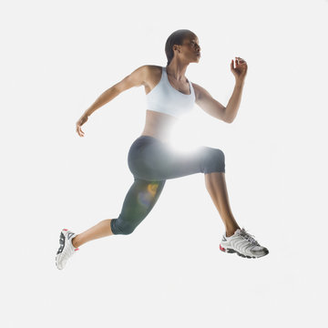 Mixed race woman jumping in mid-air