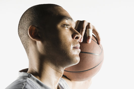 African man holding basketball