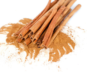 cinnamon sticks and powder on white background