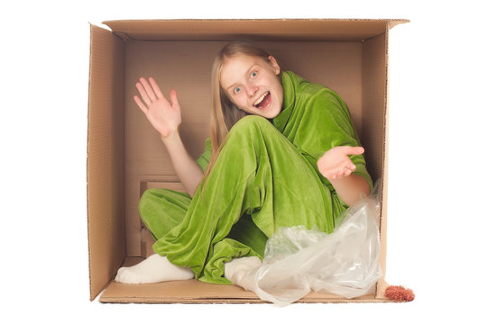 young adorable woman sit in papre box and applause