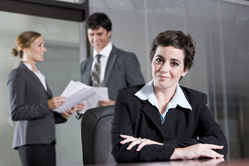 Fototapeta premium Three office workers meeting in boardroom