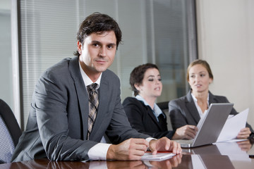 Businessman in boardroom with female colleagues