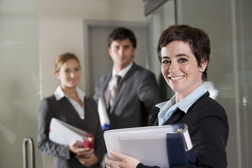 Three office workers at door of boardroom