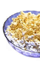 Popcorn in a blue basket. Isolated on a white background